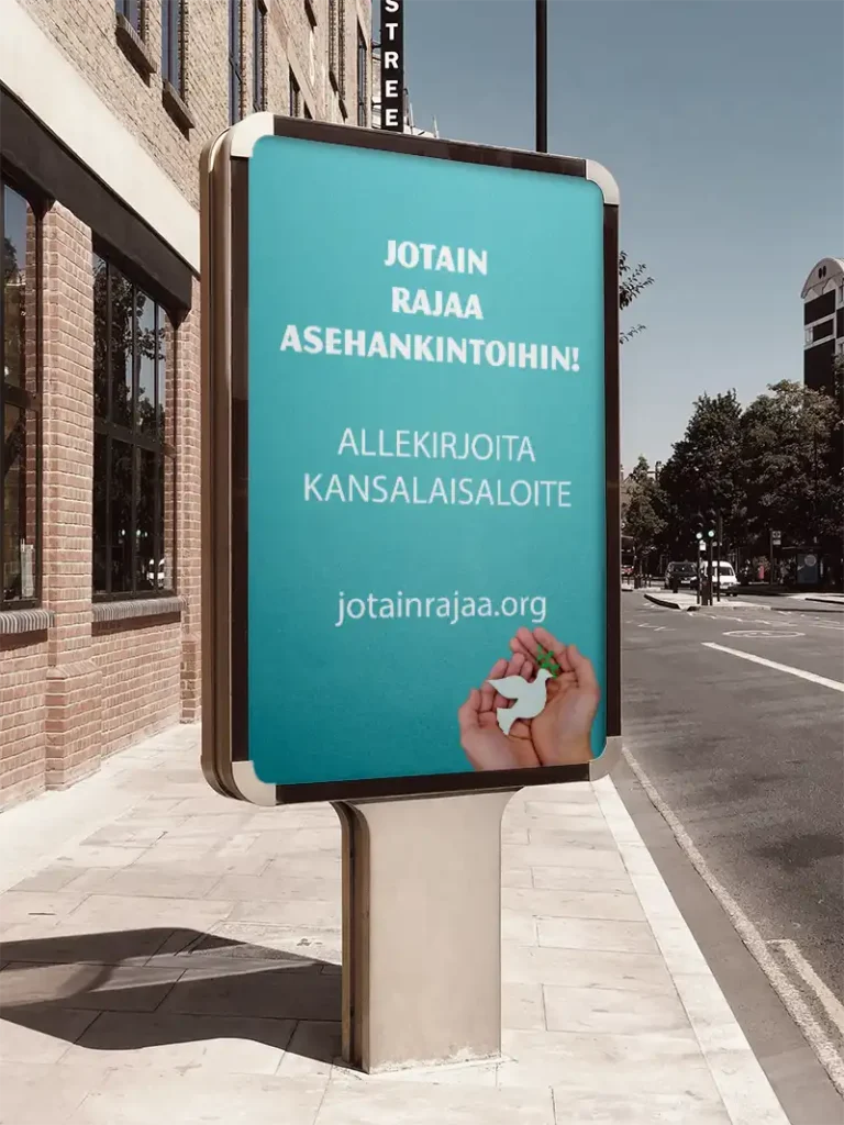 Mainostaulu kadulla, jossa teksti "Jotain rajaa asehankintoihin! Allekirjoita kansalaisaloite jotainrajaa.org". Tekstin alla kuva käsistä jotka pitelevät valkoista paperikyyhkystä, suussaan vihreä oksa.